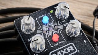 MXR Layers pedal in metallic black finish with clear controls pictured on wood floor with coiled guitar cable