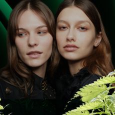 two woman with shiny hair on a green background with nettle