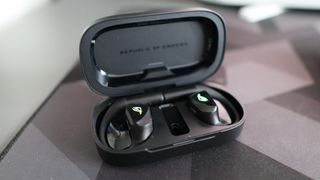 Asus ROG Cetra Open earbuds on a deskmat.