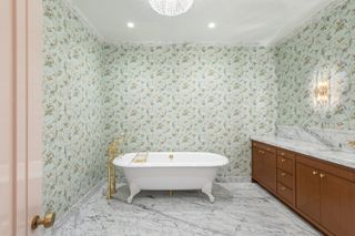 bathroom with floral wallpaper and marble floor and freestanding bath