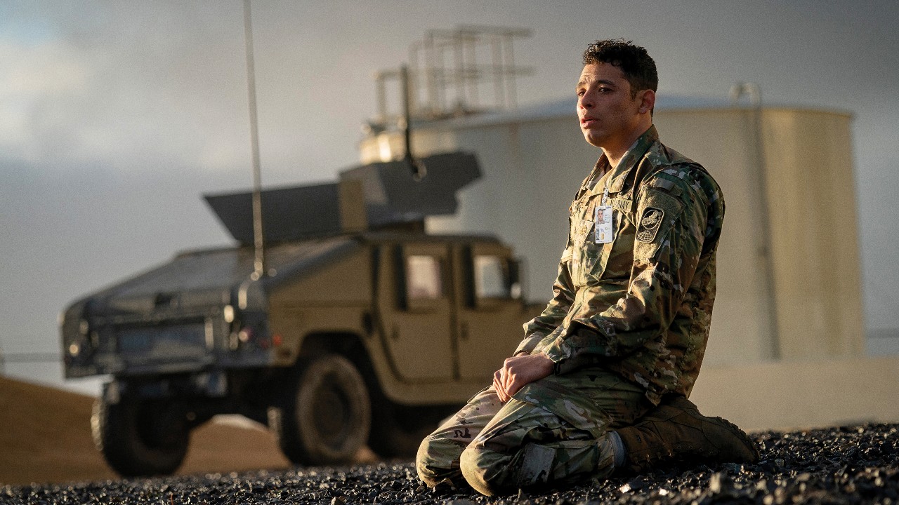 A soldier cries on the ground