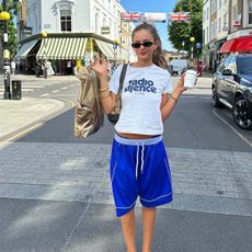 woman wearing basketball shorts and t shirt