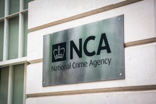 National Crime Agency (NCA) logo on a plaque attached to its headquarters