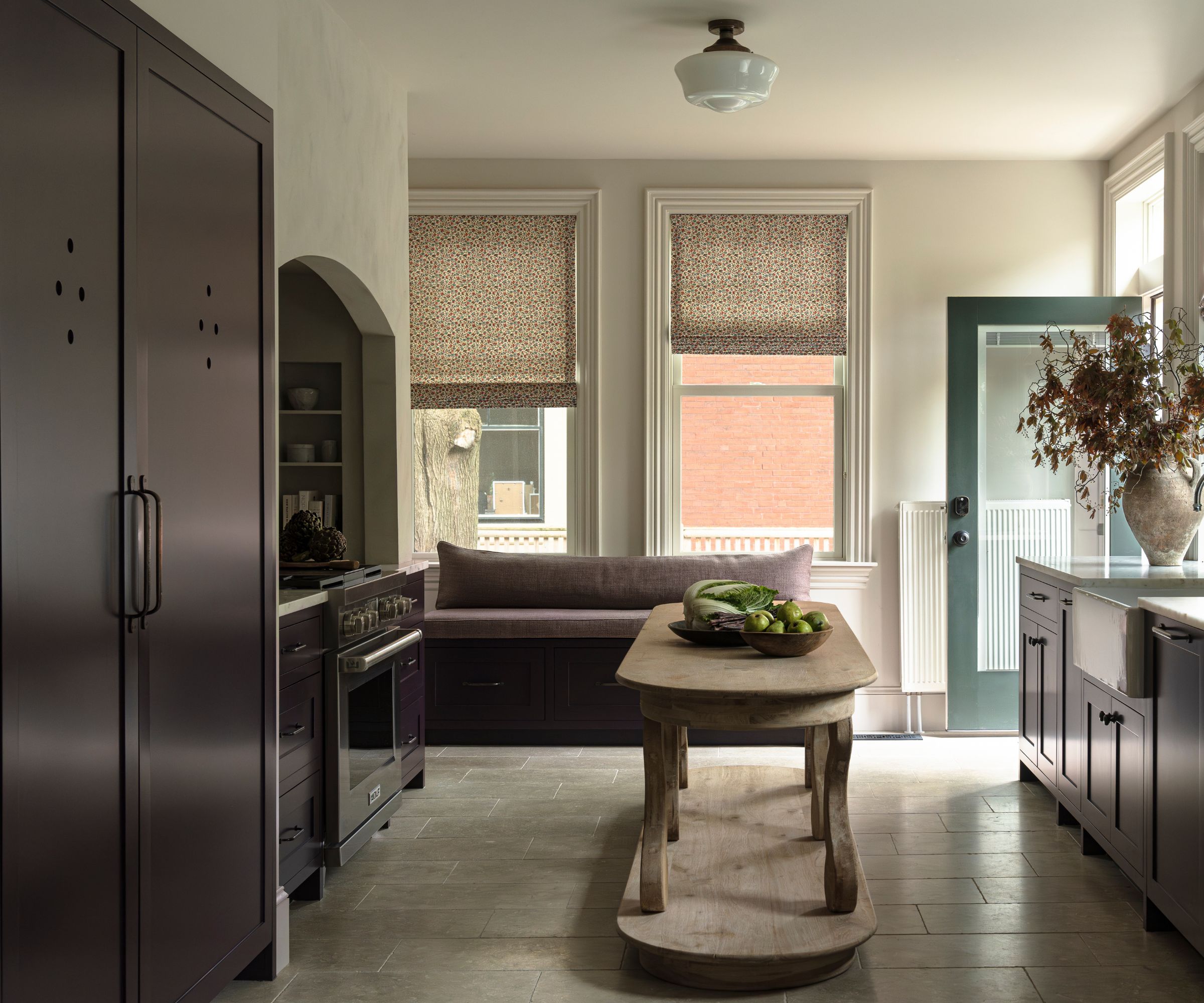A white and burgundy kitchen with cabinet cutouts