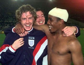 A bandaged Paul Ince, right, celebrates World Cup qualification