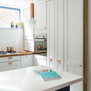 kitchen with white cabinets and bulb