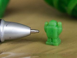 A tiny robot figurine made with Patrick Hood-Daniel's cobbled together resin printer.