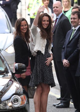 Pippa and Kate Middleton wave at paparazzi the day before the Royal Wedding