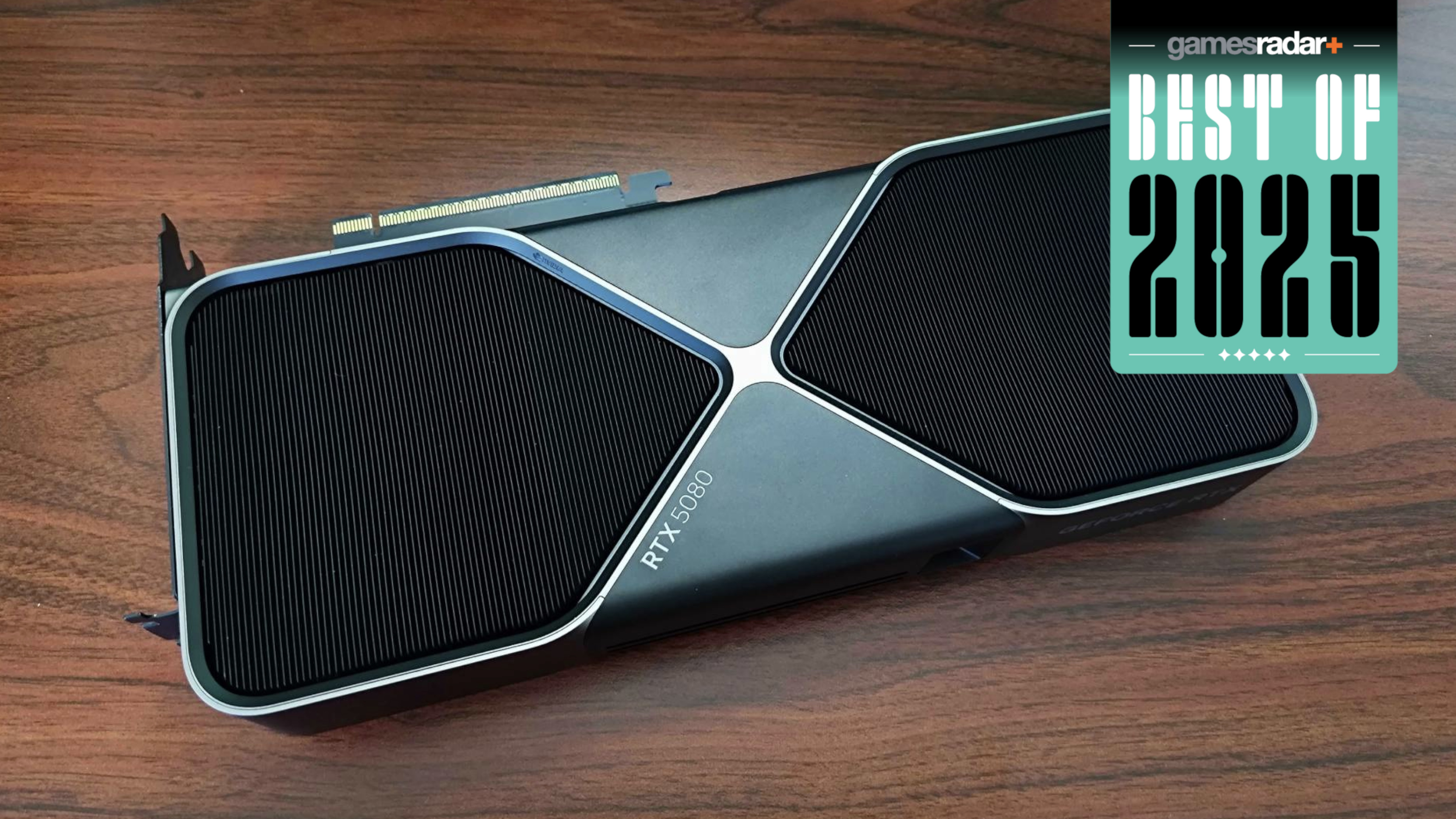 Nvidia GeForce RTX 5080 graphics card on a wooden desk with 'best of 2025' badge
