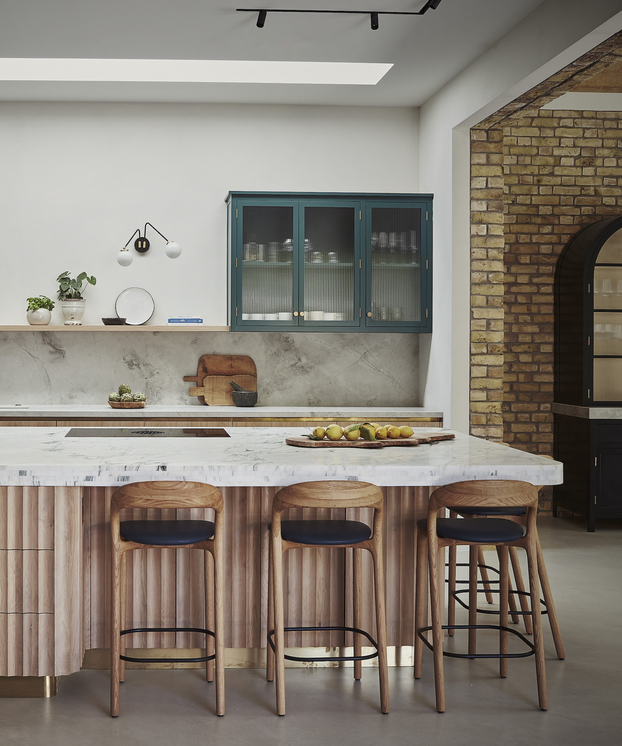 wood kitchen island with ribbed sides and bar stools