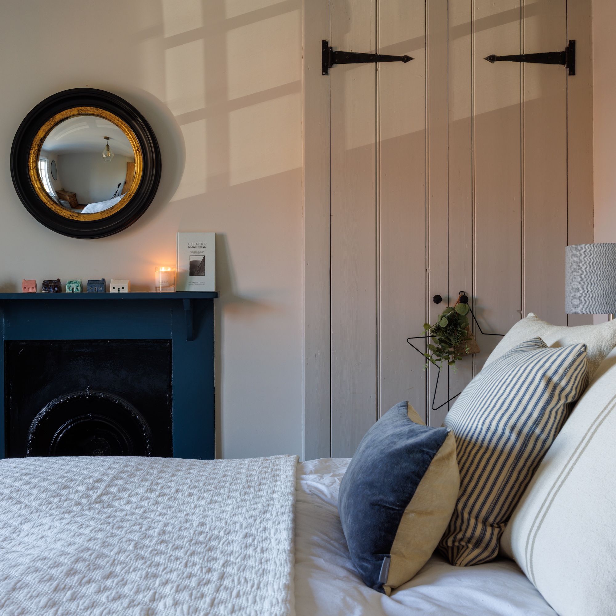 cottage bedroom with fireplace and barn door style wardrobe doors