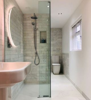 bathroom with white tiled flooring and shower