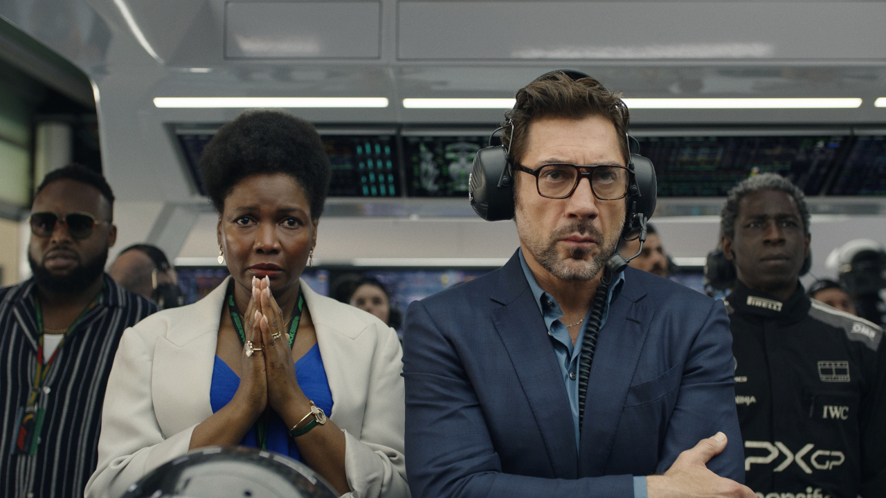 Samson Kayo, Sarah Niles, Javier Bardem, and Abdul Salis stand watching a race nervously in F1.