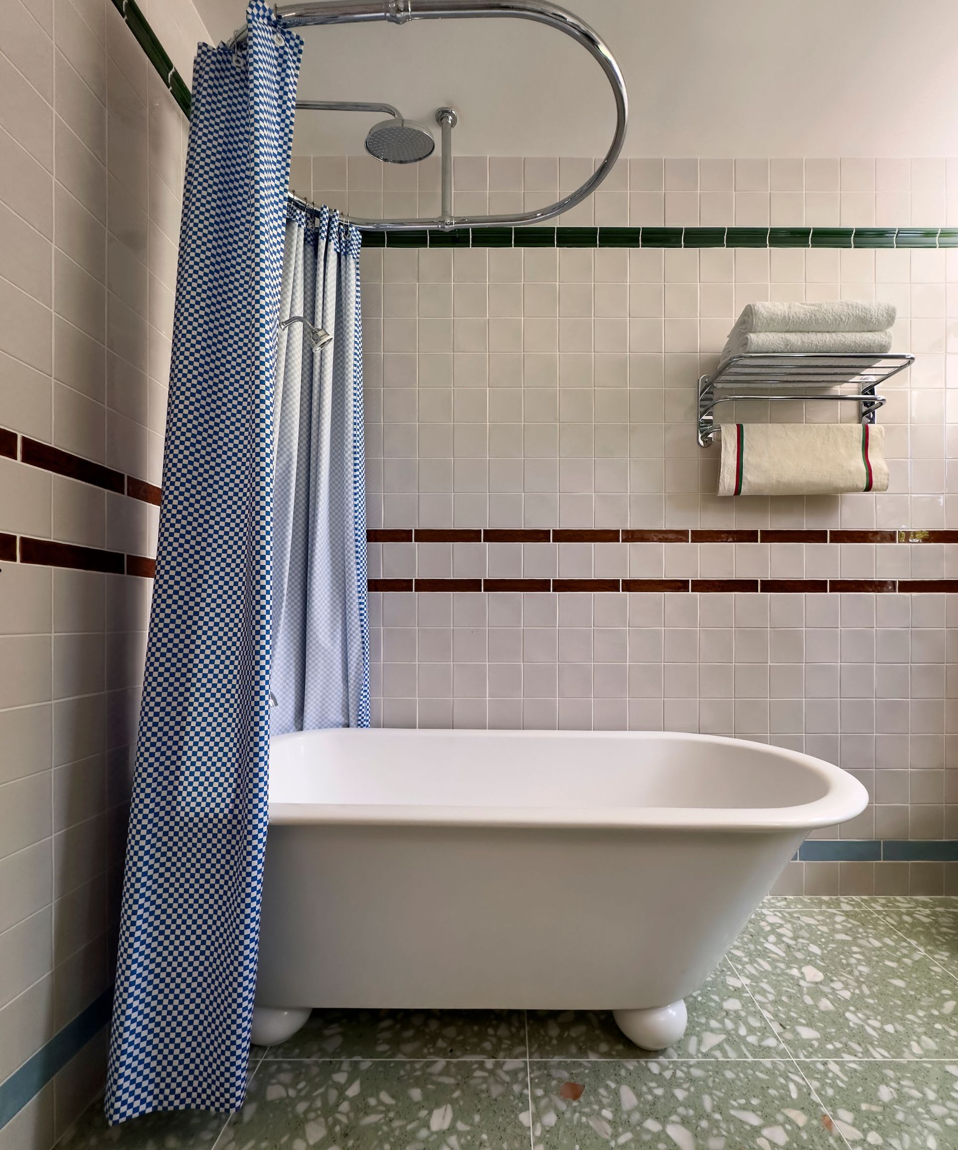 Retro bathroom with a freestanding bath surrounded by a checkerboard pattern shower curtain