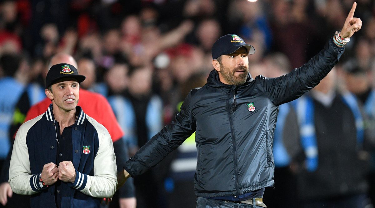 Wrexham co-owners Rob McElhenney and Ryan Reynolds celebrate after the team won the National League title at the Racecourse Ground on April 22, 2023 in Wrexham, United Kingdom.