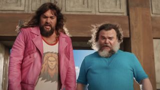 Mid shot of Jack Black and Jason Momoa's faces as they stare down from the top of a cliff in Minecraft.