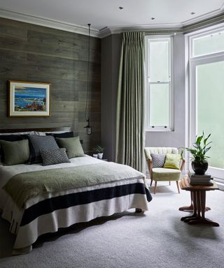 Single color scheme cozy bedroom ideas shown in restful green.