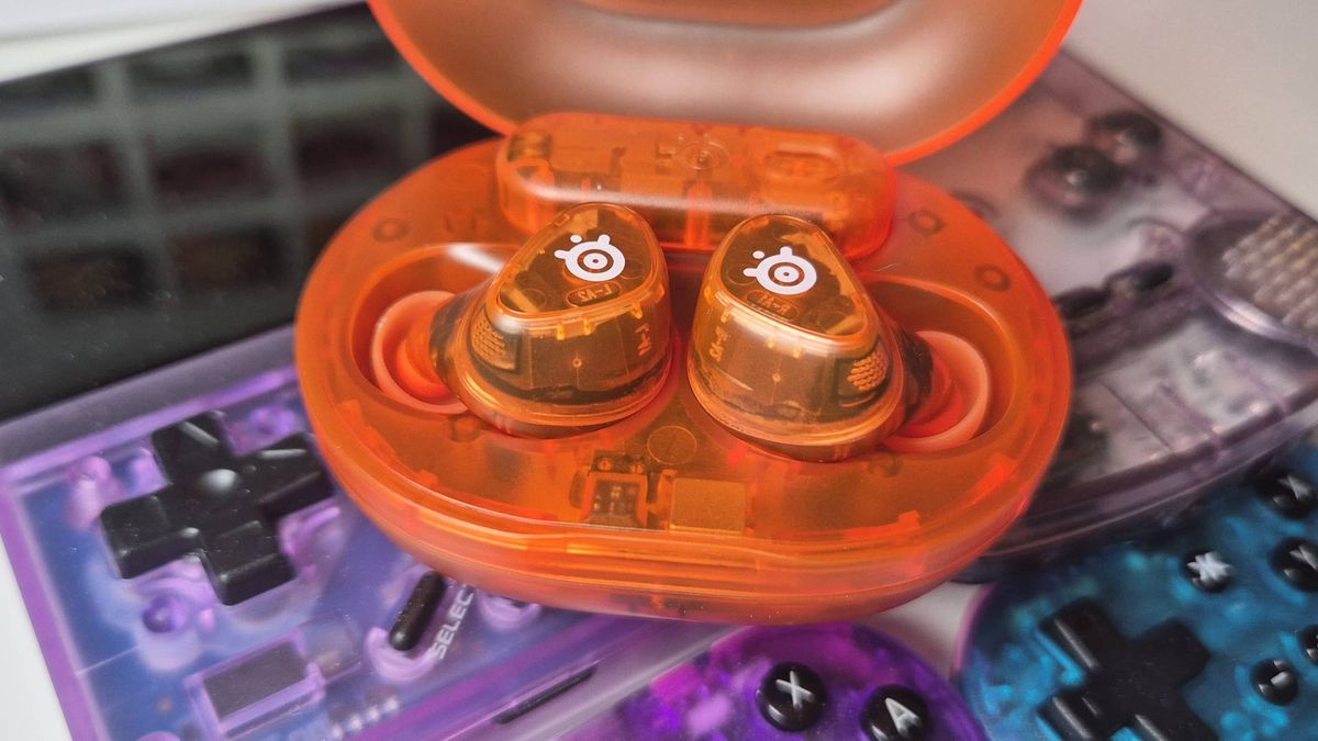 Photo of the Glorange Arctis GameBuds by SteelSeries taken by writer Rosalie Newcombe, sitting on top of the Atomic Purple Miyoo Mini Plus and Game Boy Color.