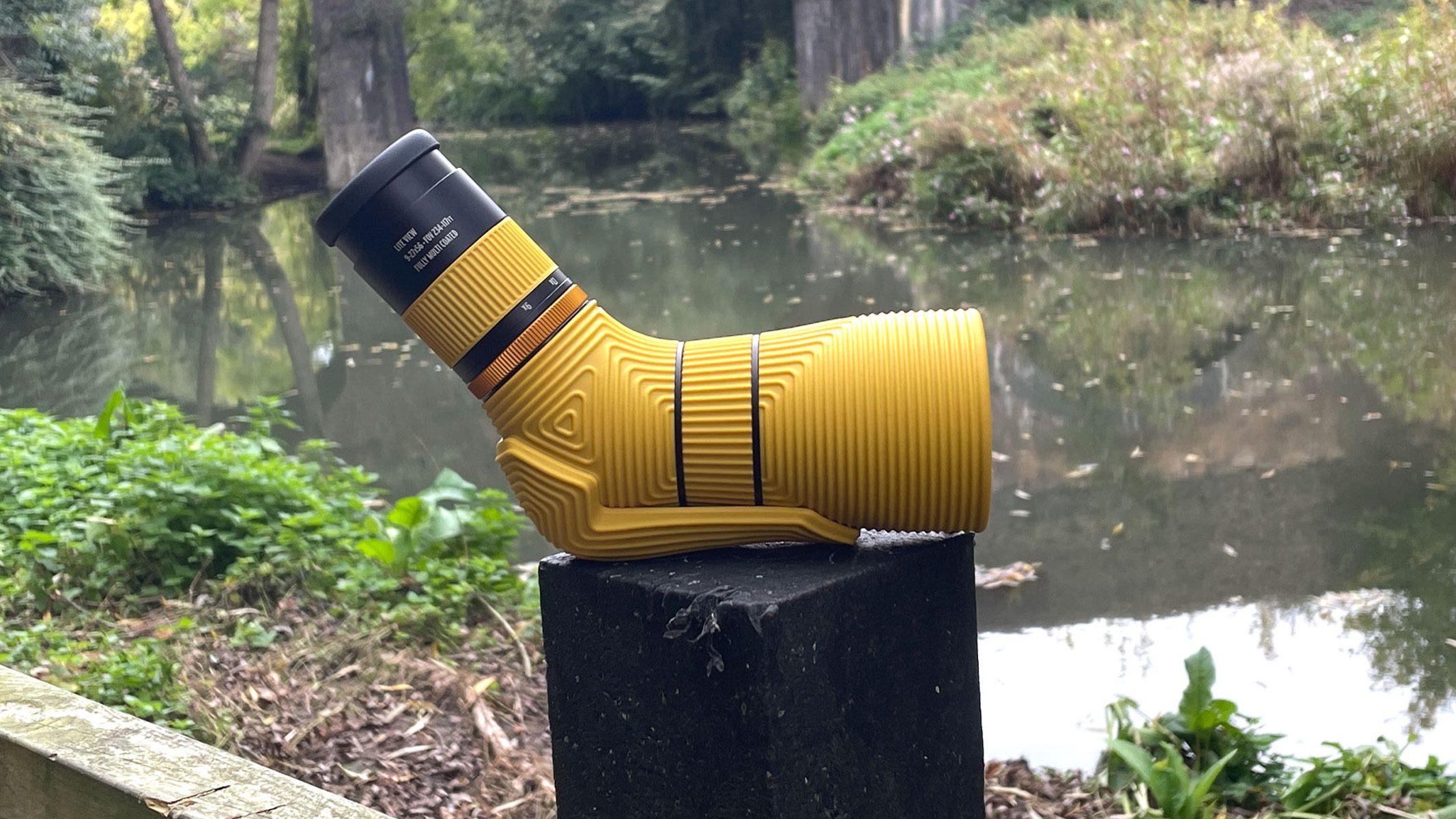 Nocs Provisions Lite View spotting scope on a wooden post in front of a river