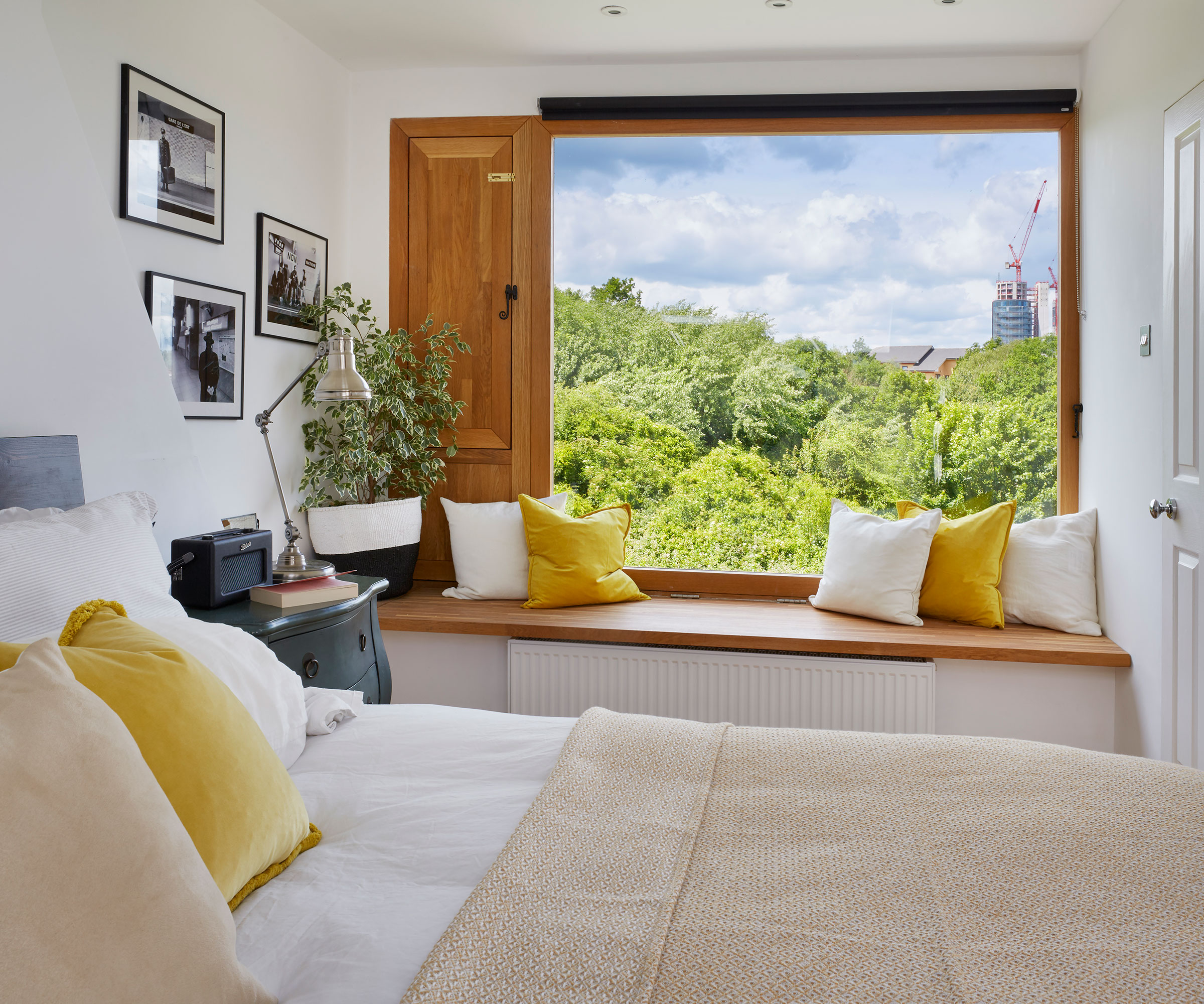 small bedroom with picture window and window seat