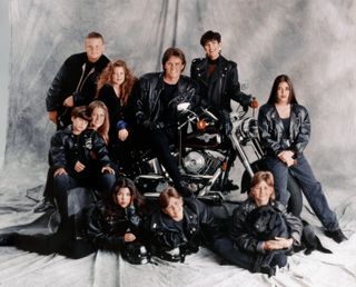 The Kardashian family surround a motorcycle dressed in leather jackets for a family portrait.