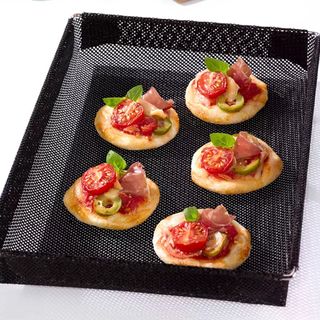 NoStik Non-Stick Oven Crisper Basket, Small with mini pizzas cooking on top