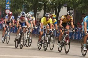 Tour leader Justin Jules (yellow) of Velo Club/La Pomme Marseille in the peloton on stage six in Chengmai.