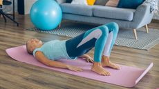 woman in glute bridge position on yoga mat