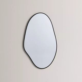 Aria Blob Wall Mirror with slim black frame hung on plain wall