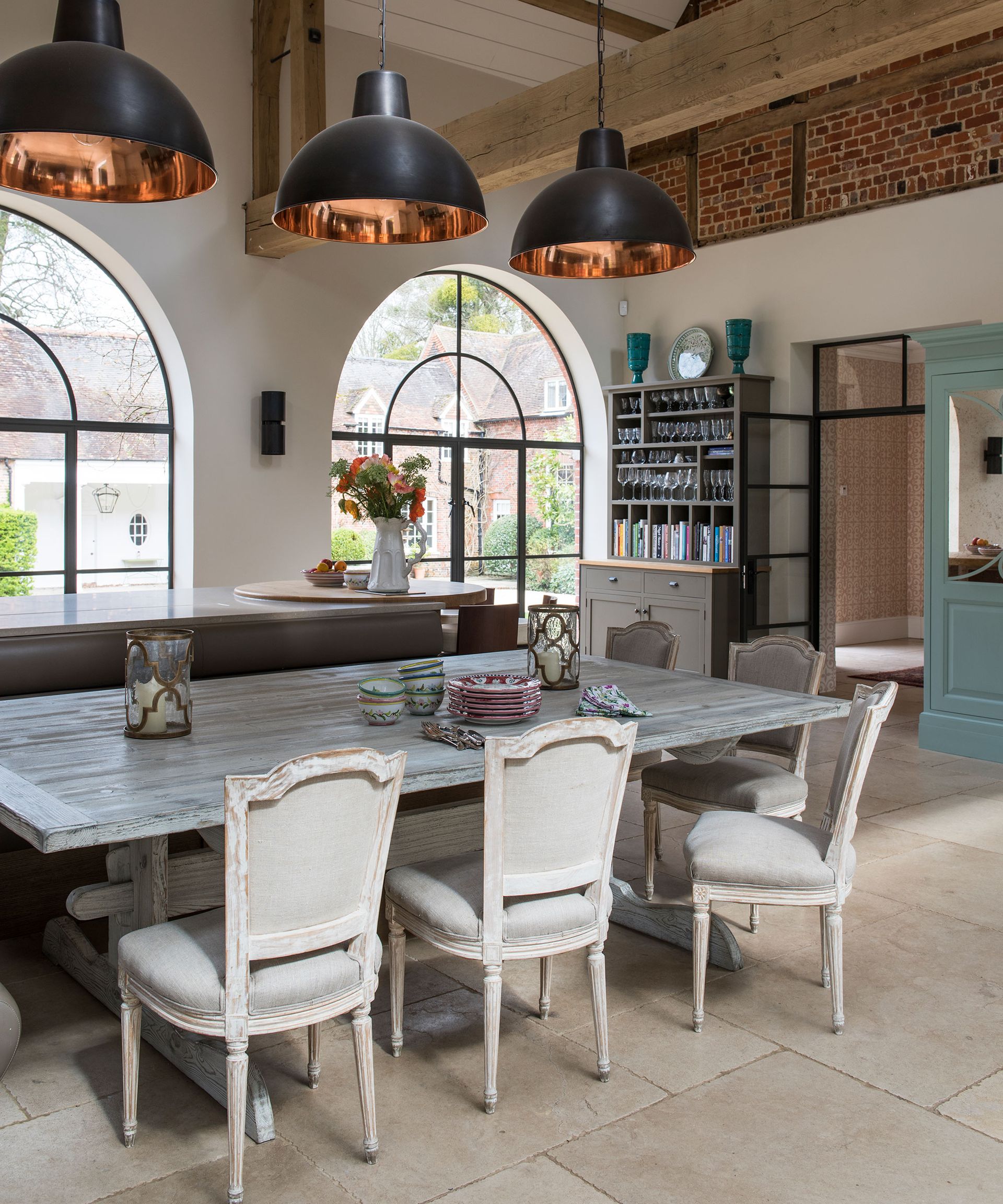 Dining room with farmhouse table and black pendant lights