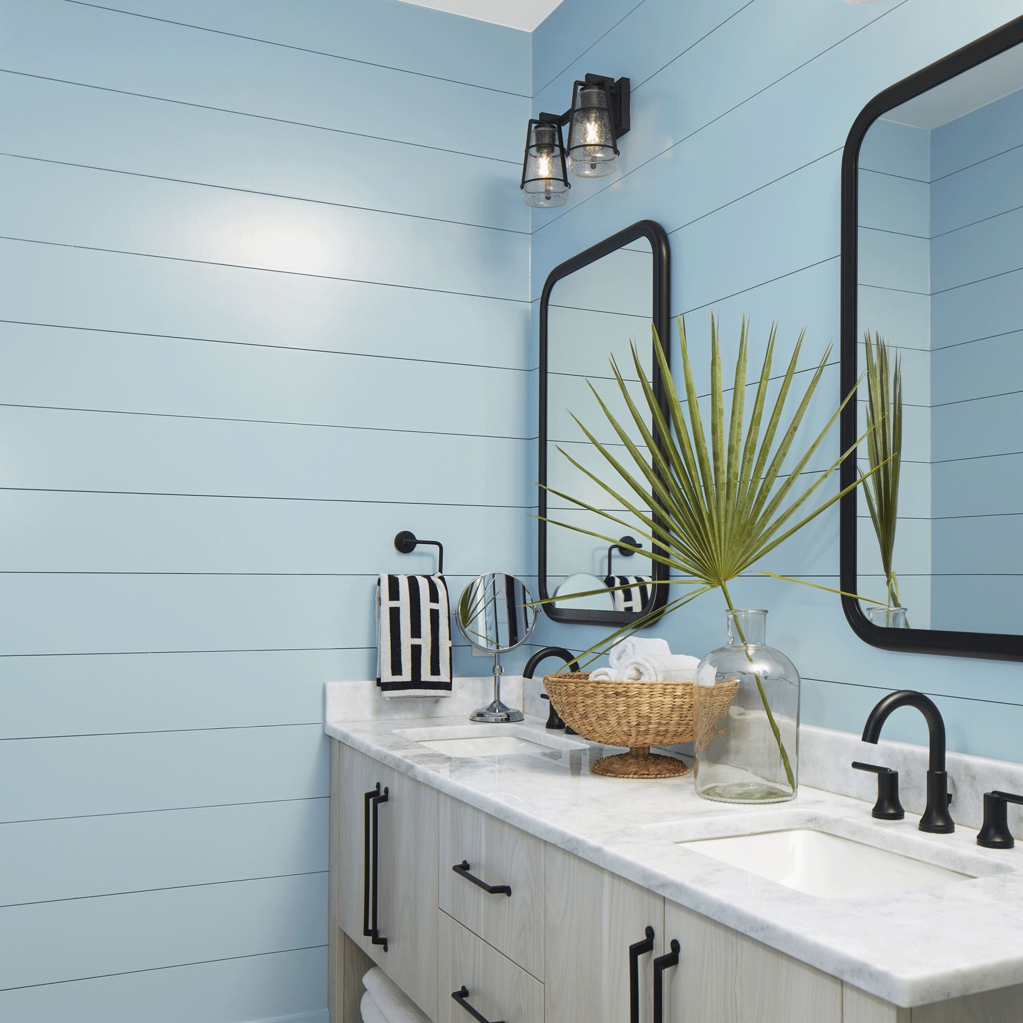 Blue bathroom with silver mirrors