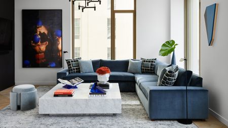 a modern apartment living room with a blue sofa