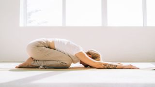 A woman doing the Child's Pose during yoga