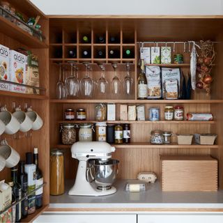 kitchen pantry with wooden shelves and food items
