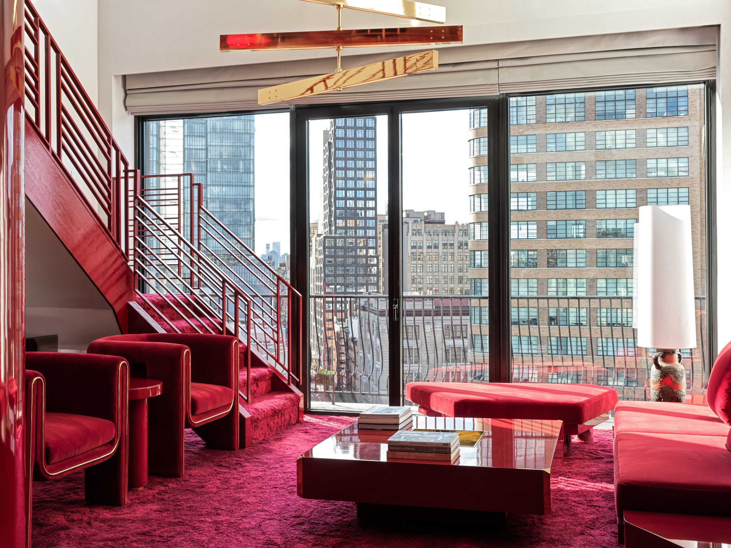 Crimson red hotel room overlooking SoHo in New York