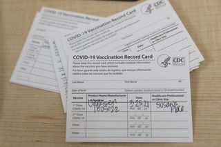 Covid-19 Vaccination Record Cards during a Care For The Homeless vaccination event at the Health Center of Susan's Place Shelter For Women in the Bronx borough of New York, U.S., on Thursday, March 25, 2021.