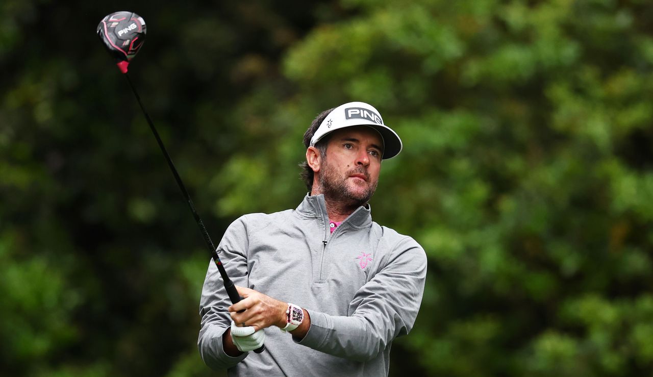 Bubba Watson strikes his tee shot with a driver and watches the flight of it