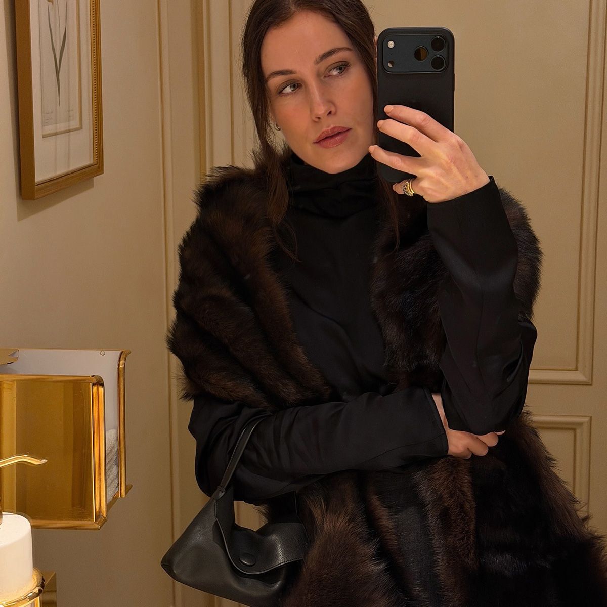 Annabel wears a fur coat and the row sally bag.
