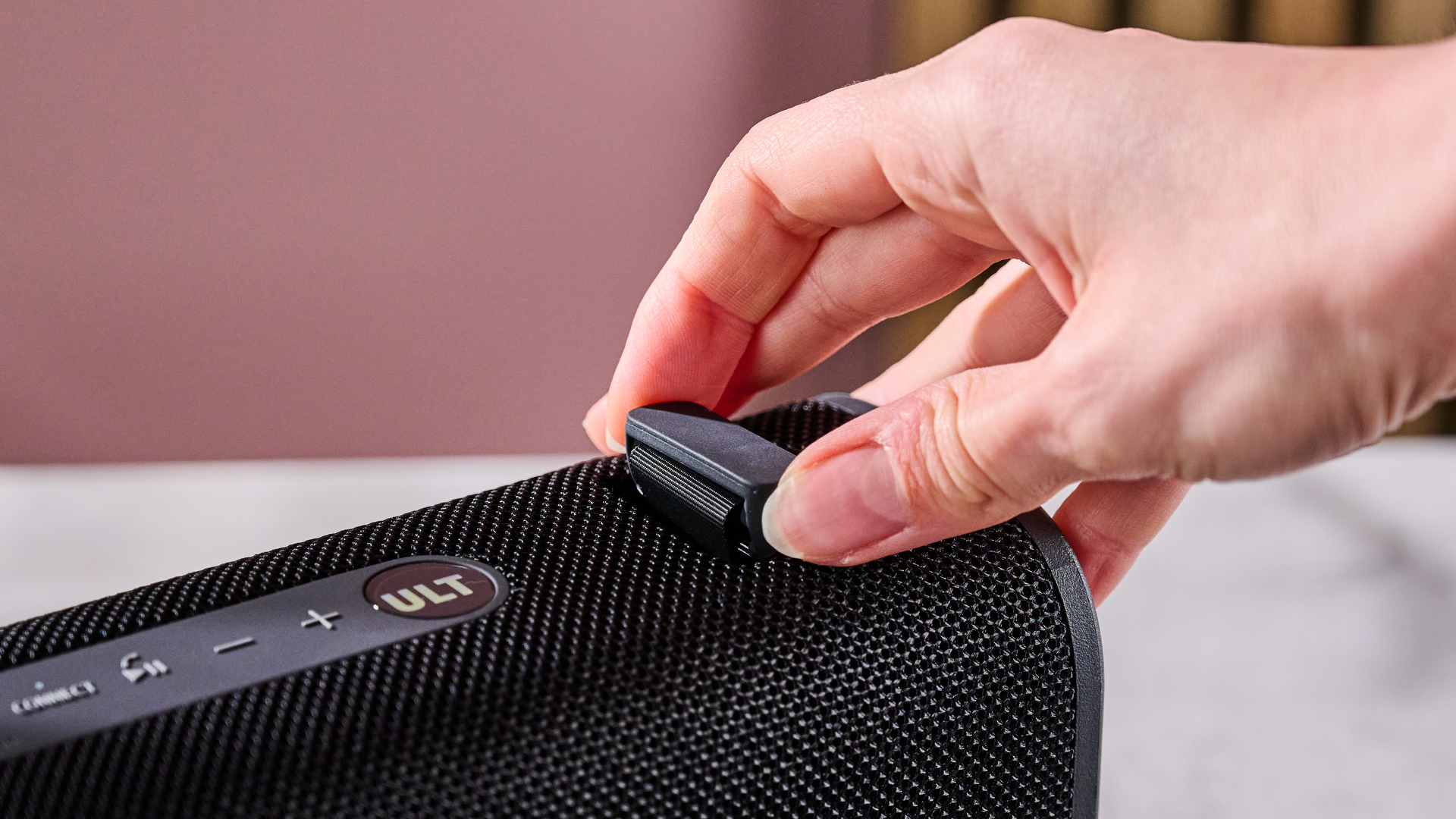 Hand adjusting the strap on the Sony ULT Field 3