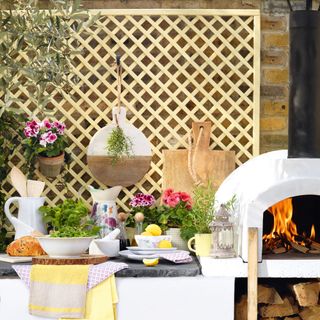 outdoor kitchen with white counter and flower plants