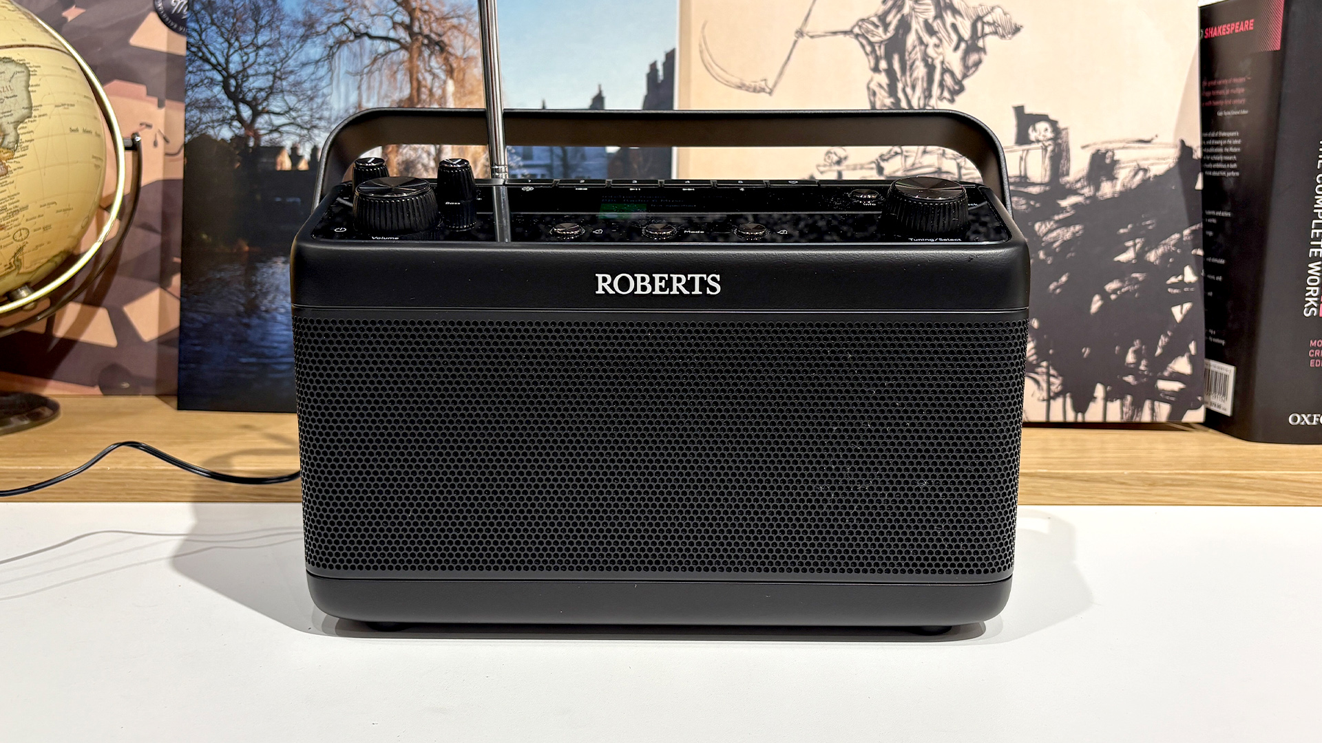 Roberts Stream 219 radio on white surface in front of records, books and a globe