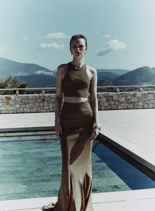 Woman in top and skirt by the pool
