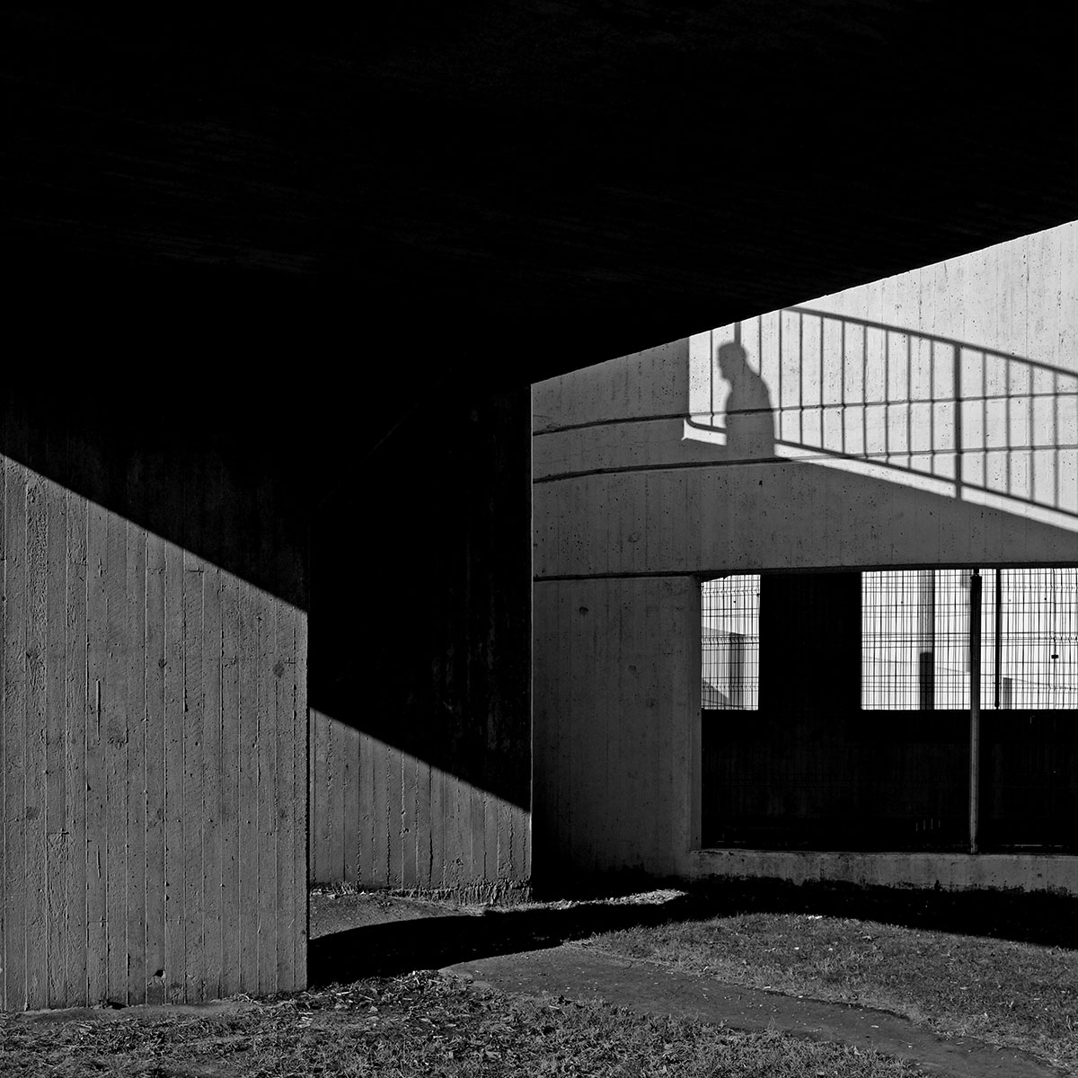 Shadow of someone walking up outdoor staircase