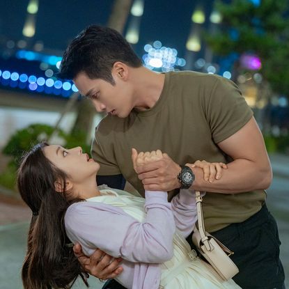 A man (actor Ahn Bo-hyun) holds a woman (actress Lee Joo-bin) in a dip, as the pair stands outdoors in a park at night. A still from the Prime Video K-drama 'Spring Fever.'
