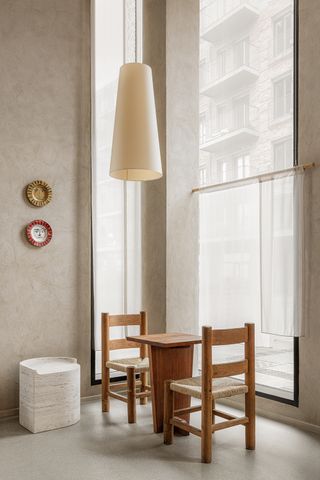 minimaluxe dining room with lime wash grey walls and wood chairs