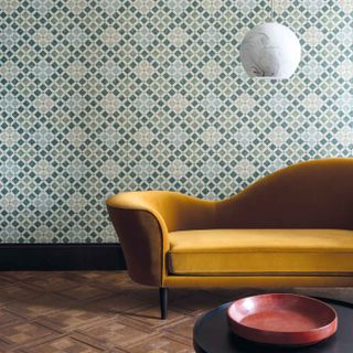 moroccan style tiled wallpaper with bright yellow sofa