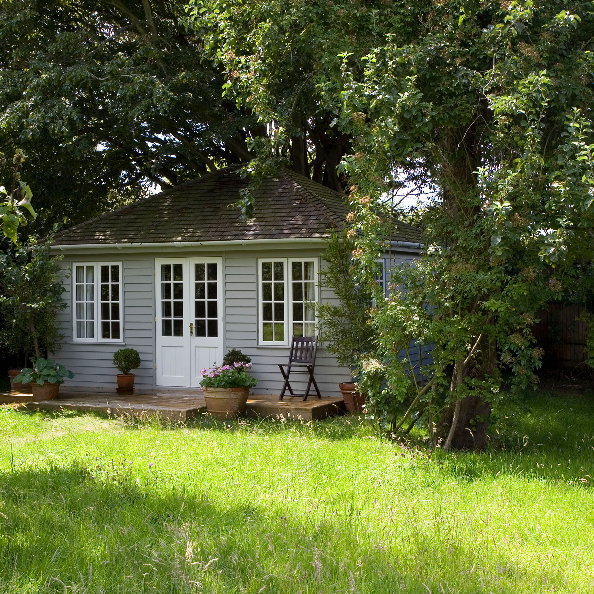 exterior of cottage with potted plant and sash window