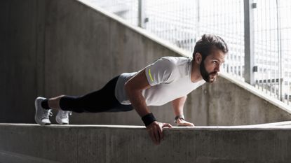 Man holding a plank