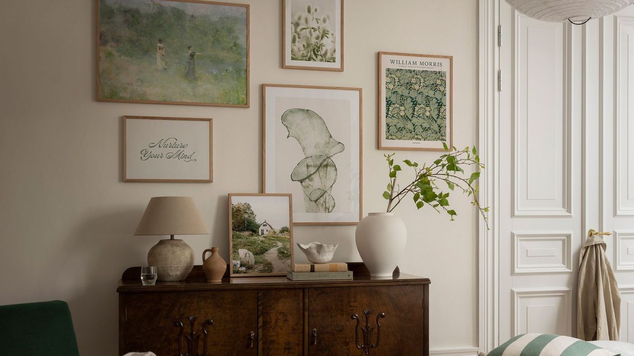 A bedroom gallery wall made up of sage green prints