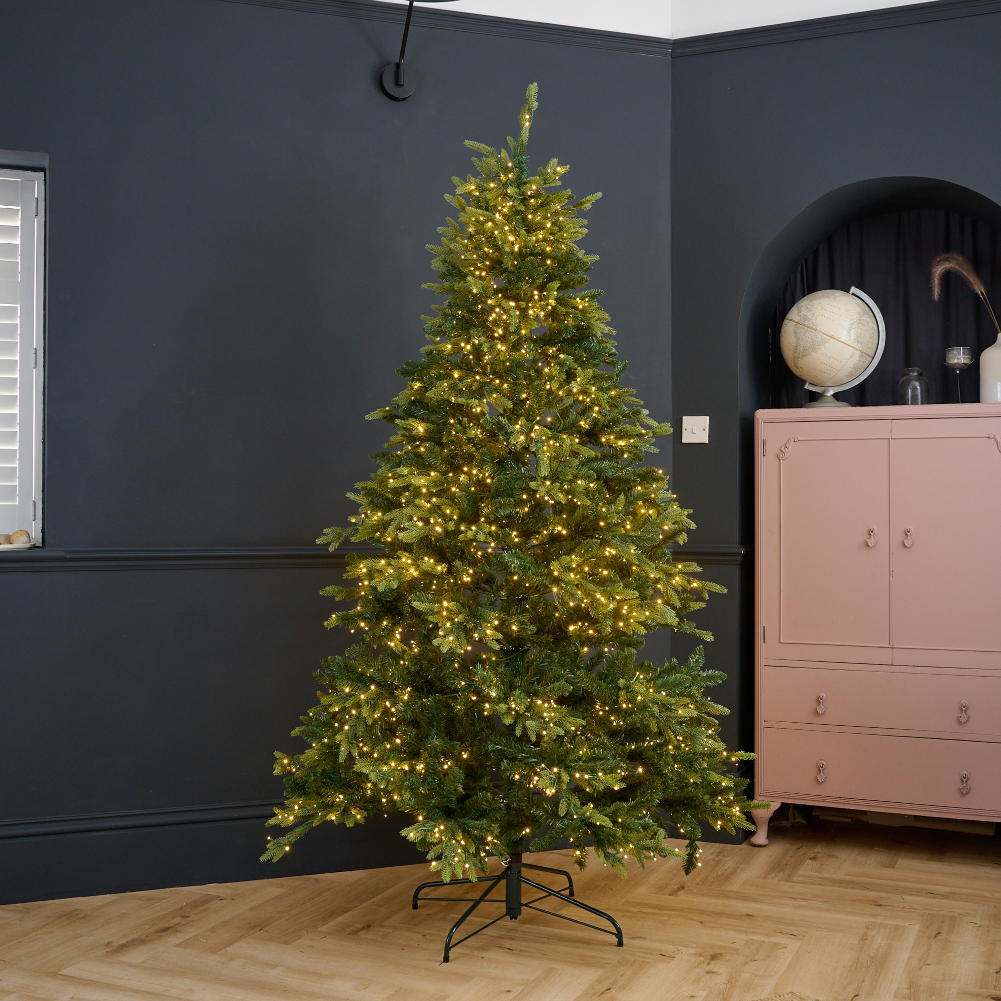 Habitat's 7ft Pre Lit Natural Look Christmas Tree in a black-painted living room